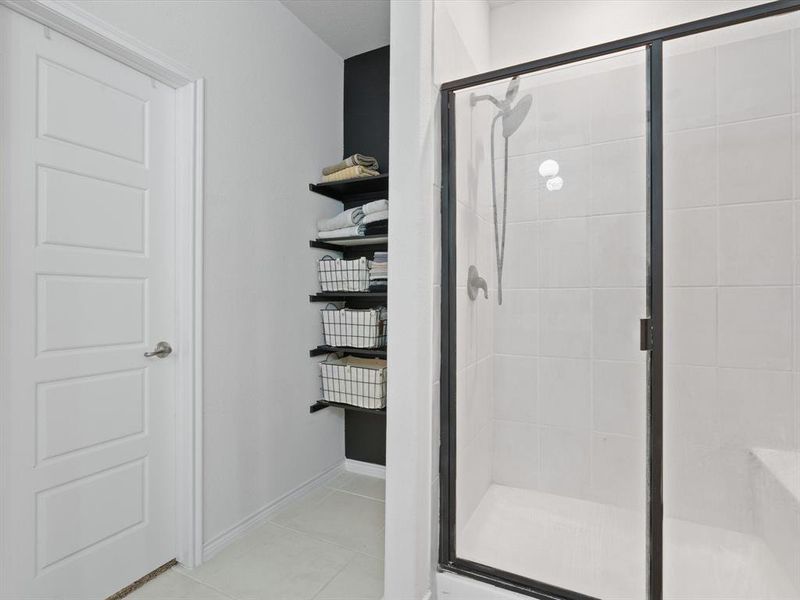 Bathroom featuring tile patterned floors and an enclosed shower