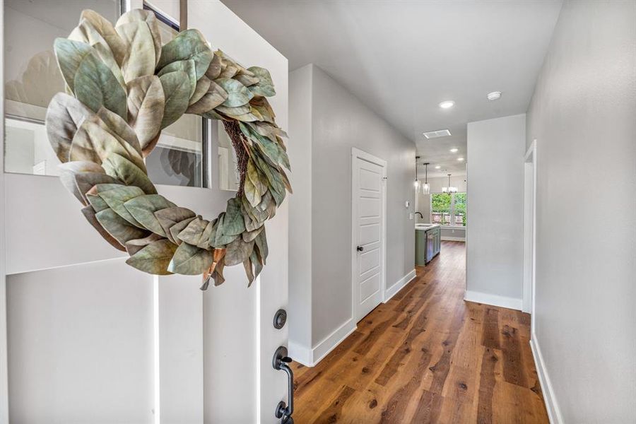 Hallway with dark wood finished floors and recessed lighting Hallway with dark wood finished floors and recessed lighting