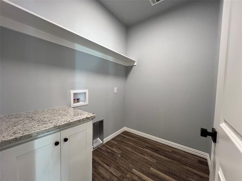 Laundry room featuring cabinets, hookup for a washing machine, and dark hardwood / wood-style flooring