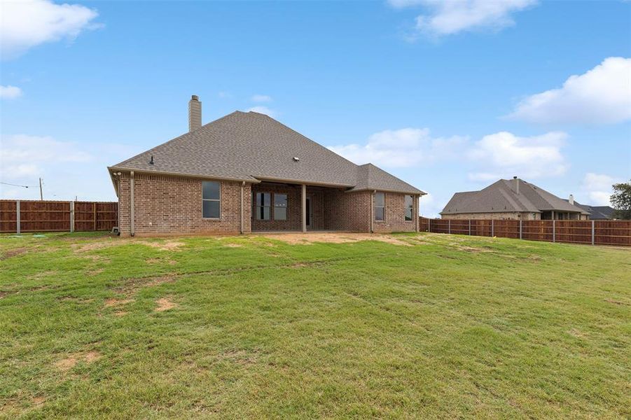 Back of property with a patio and a yard