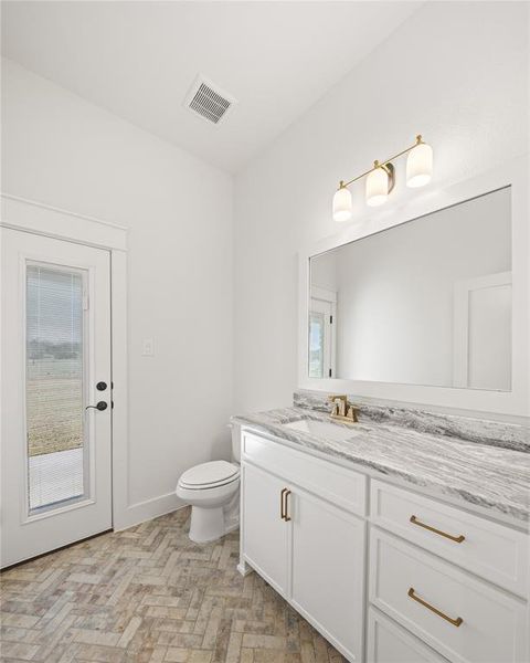 Bathroom with toilet and vanity