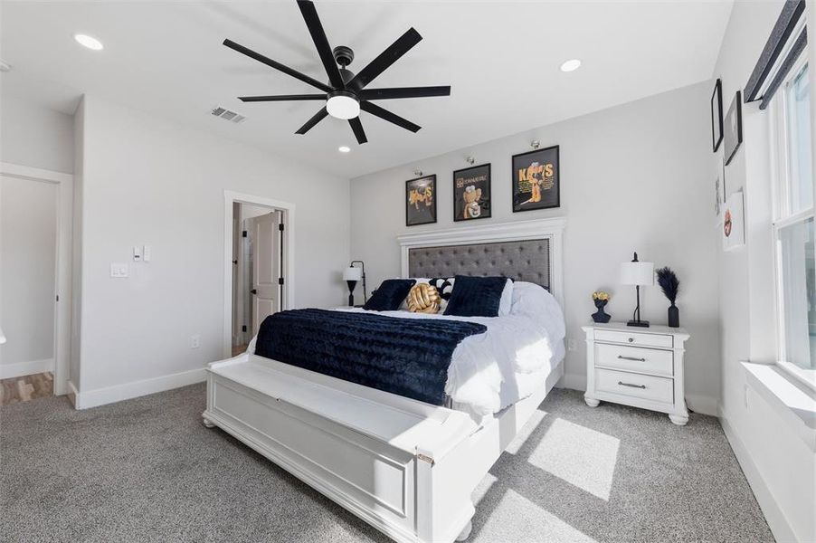Bedroom featuring light carpet, a ceiling fan, and recessed lighting