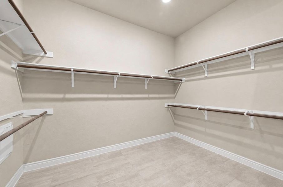 Ample shelving and hanging space defines this generously sized walk-in closet. Ample shelving and hanging space defines this generously sized walk-in closet.