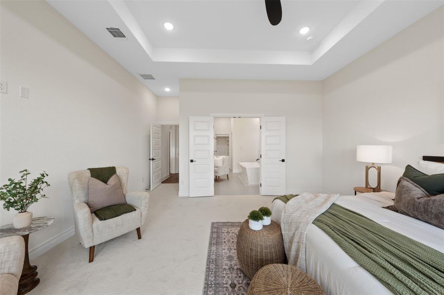 Bedroom featuring carpet, a tray ceiling, connected bathroom, recessed lighting, and ceiling fan Bedroom featuring carpet, a tray ceiling, connected bathroom, recessed lighting, and ceiling fan