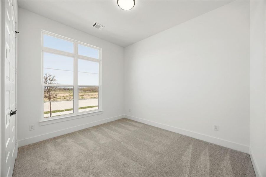 Spare room with light colored carpet