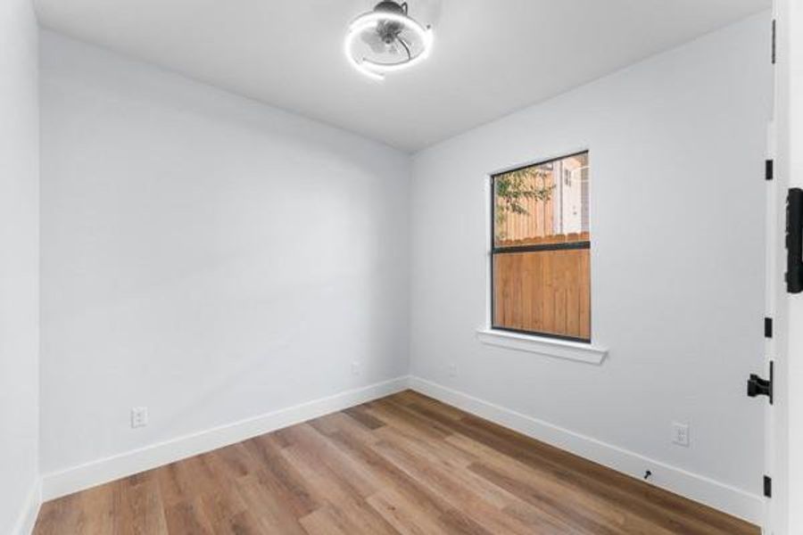 Spare room featuring baseboards and light wood-style floors Spare room featuring baseboards and light wood-style floors
