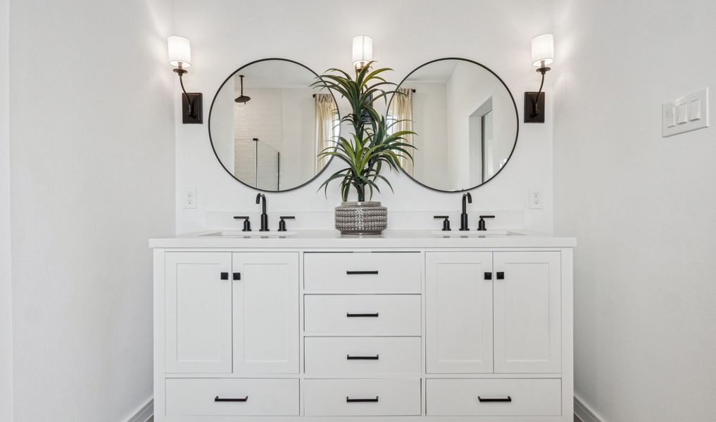 Primary bath features freestanding vanity with dual sinks