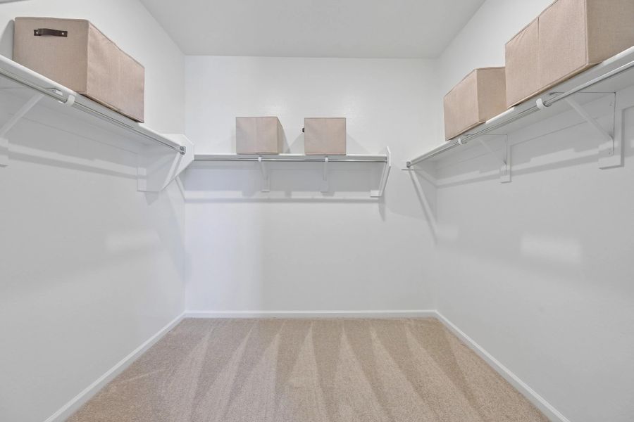 Primary walk in closet. Model home, finishes may vary. Primary walk in closet. Model home, finishes may vary.