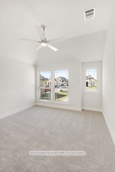 Empty bedroom with vaulted ceiling, ceiling fan, carpet flooring, and two windows overlooking a neighborhood street. Empty bedroom with vaulted ceiling, ceiling fan, carpet flooring, and two windows overlooking a neighborhood street.