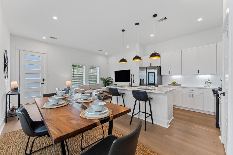 This inviting home features a spacious open-concept layout on the first floor, seamlessly connecting the living, dining, and kitchen areas to create a warm and functional gathering space. Large windows and glass door direct access to the front yard flooding the interior with natural light and extending the living space outdoors, perfect for entertaining or relaxing in the fresh air. The thoughtful design balances comfort and flow, making everyday living feel effortlessly connected to nature.