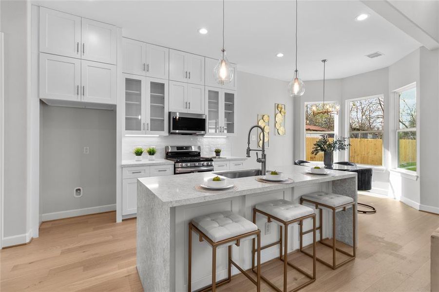 Chef's dream kitchen featuring quartz countertops, soft-close cabinetry, and a large center island.