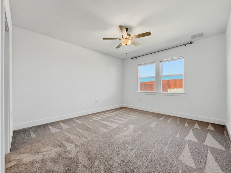 Bedroom featuring light colored carpet and ceiling fan