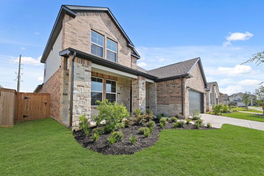 Front exterior of a new home in Sunterra, Katy, TX, highlighting curb appeal (Image 19). Front exterior of a new home in Sunterra, Katy, TX, highlighting curb appeal (Image 19).