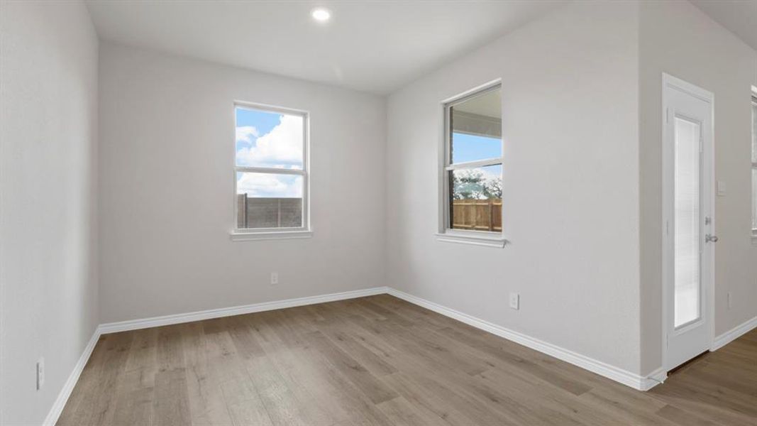 Spare room with light wood-style flooring, plenty of natural light, and recessed lighting