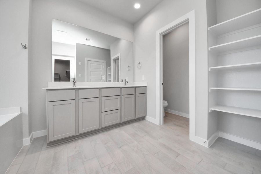 Elevate your daily routine at the elegant vanity, now equipped with double sinks, light countertops, modern hardware, and beautiful recessed lights. Sample photo of completed home with similar floor plan. Actual colors and selections may vary. Elevate your daily routine at the elegant vanity, now equipped with double sinks, light countertops, modern hardware, and beautiful recessed lights. Sample photo of completed home with similar floor plan. Actual colors and selections may vary.