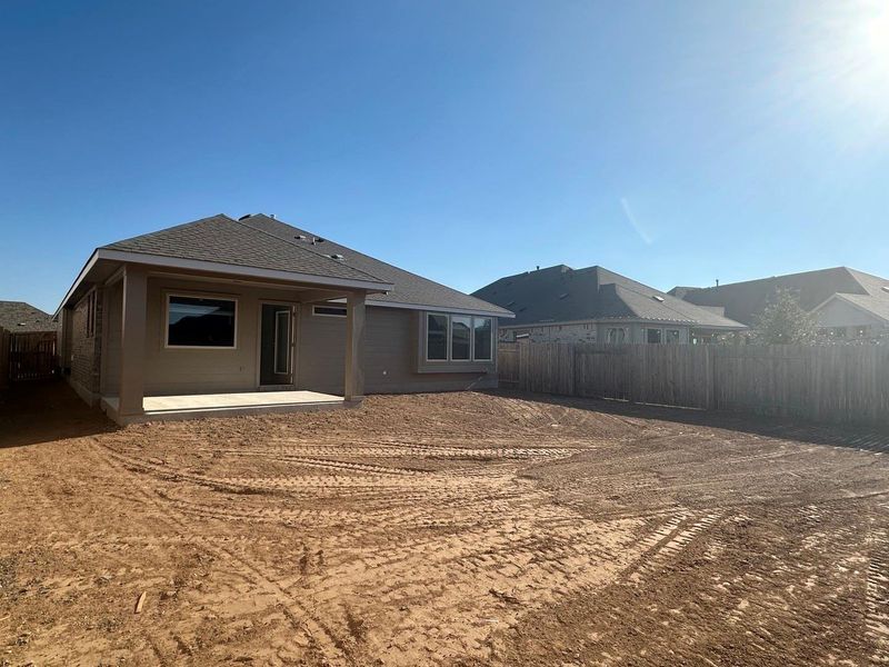 Back of house featuring a patio area, a fenced backyard, and roof with shingles Back of house featuring a patio area, a fenced backyard, and roof with shingles
