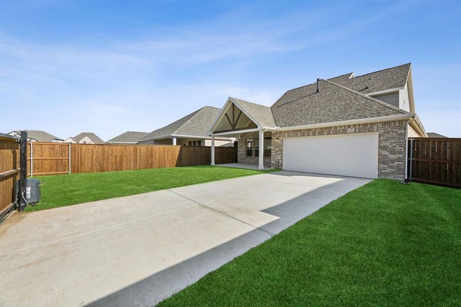 View of front of house featuring a garage and a front lawn