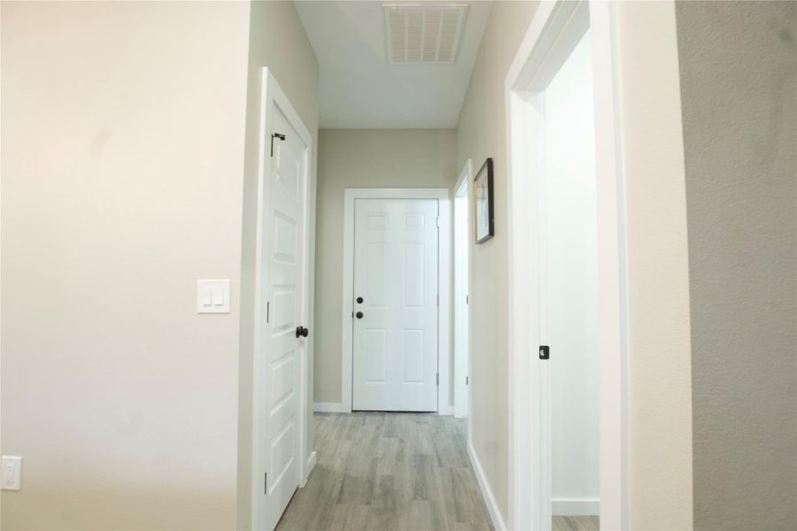 Hallway featuring light wood-style floors and baseboards