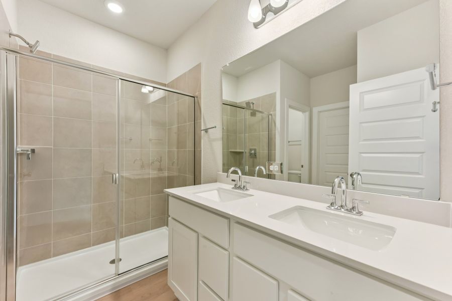 A bathroom with a glass shower. A bathroom with a glass shower.