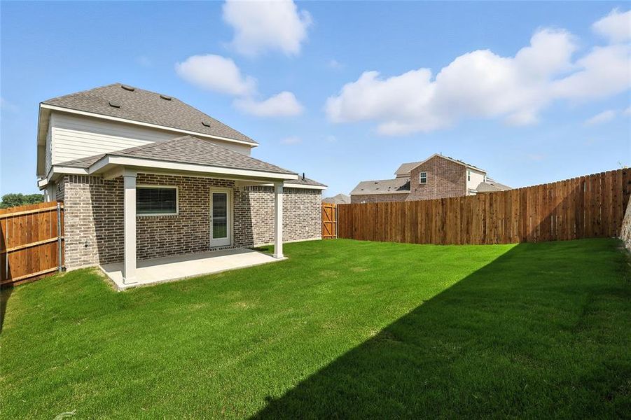 Rear view of house featuring brick siding, a shingled roof, a patio, and a fenced backyard Rear view of house featuring brick siding, a shingled roof, a patio, and a fenced backyard