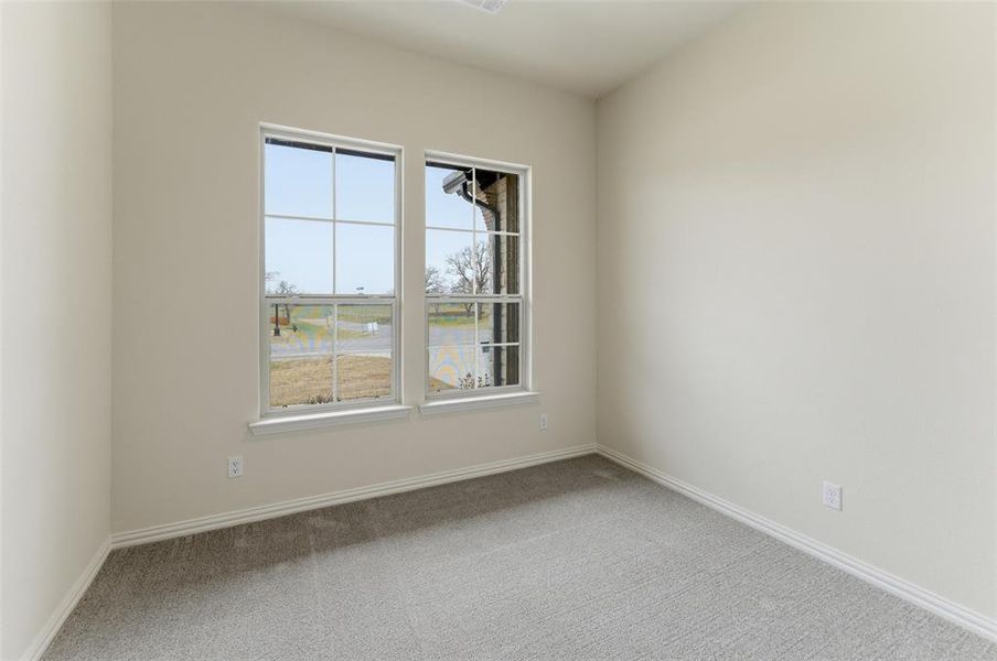 Spare room featuring light colored carpet and baseboards