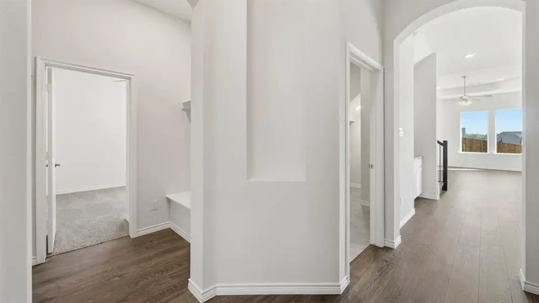 Corridor featuring arched walkways and dark wood-type flooring Corridor featuring arched walkways and dark wood-type flooring