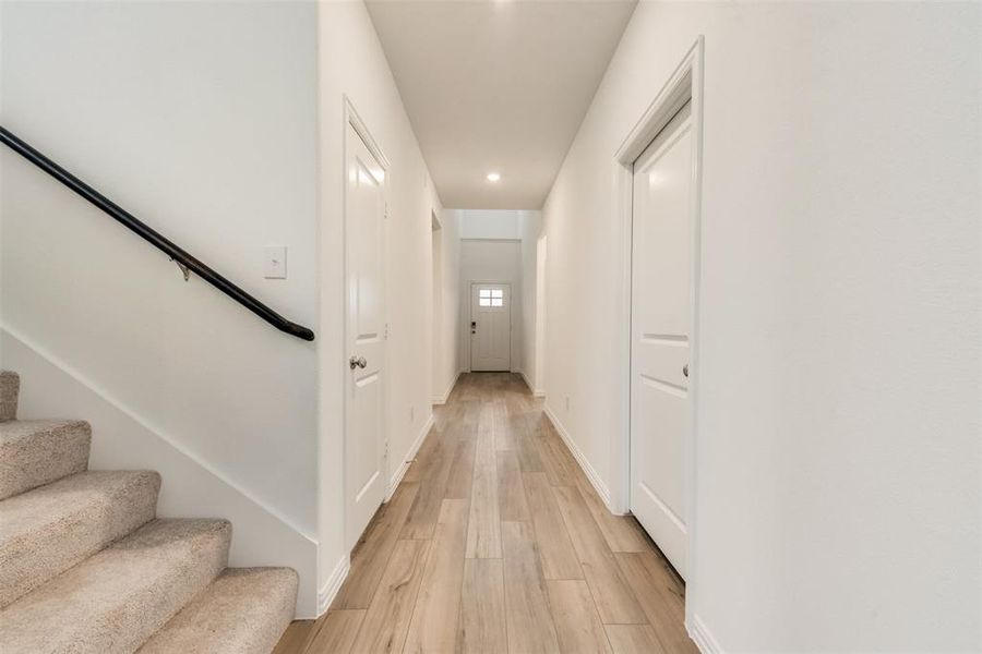 Hall with light hardwood / wood-style floors