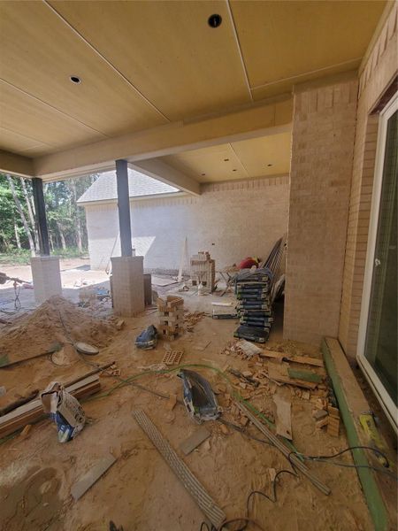 UNFINISHED BACK PATIO WITH OUTDOOR KITCHEN BEING INSTALLED WITH WHITE BIRCH BRICK