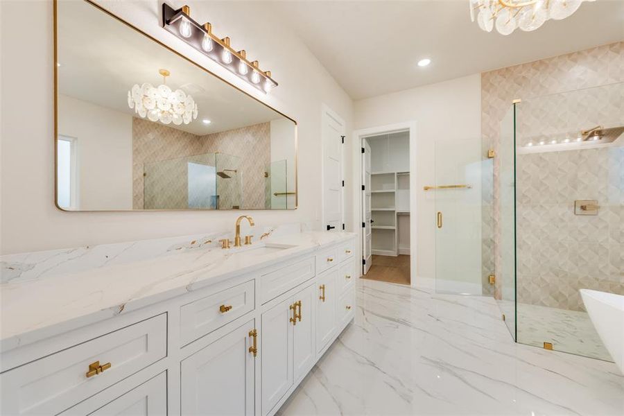 Bathroom with a chandelier, a stall shower, vanity, marble tiled flooring, and a spacious closet Bathroom with a chandelier, a stall shower, vanity, marble tiled flooring, and a spacious closet
