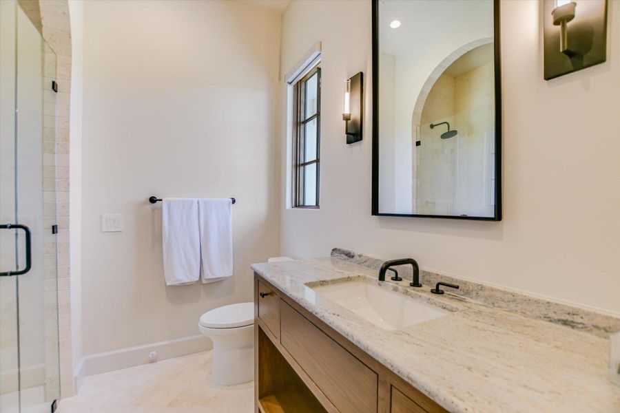 Full bathroom featuring vanity and a shower stall