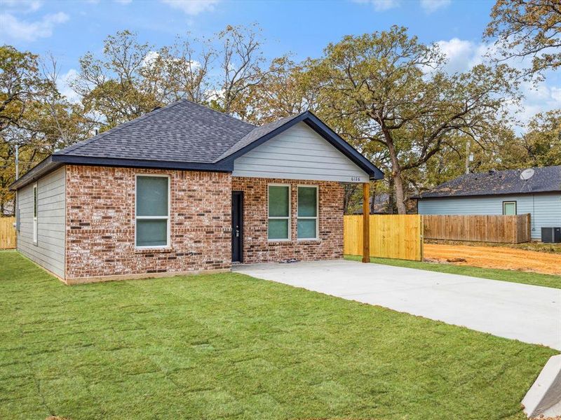 View of front of home with brick siding and roof with shingles