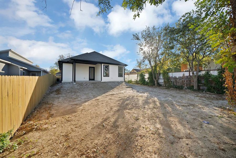 Rear view of house with a patio and roof with shingles