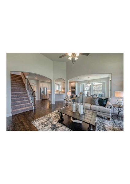 Living room featuring dark hardwood / wood-style flooring and ceiling fan