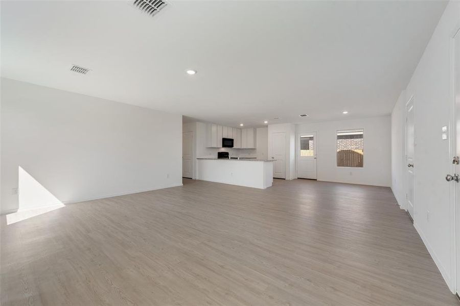 Unfurnished living room featuring light wood-type flooring