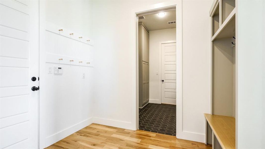 Mudroom with light wood-type flooring