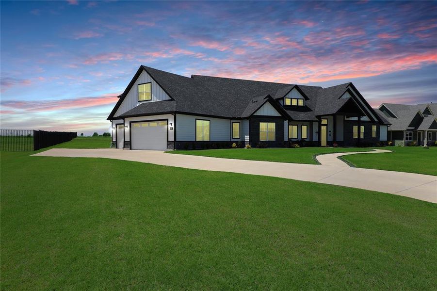Modern farmhouse featuring concrete driveway, a garage, a shingled roof, board and batten siding, and stone siding Modern farmhouse featuring concrete driveway, a garage, a shingled roof, board and batten siding, and stone siding