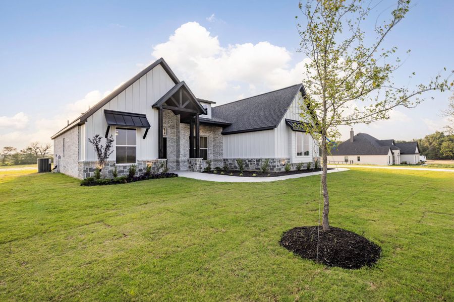 Front exterior of a new home in Prairie Winds Estates, Poolville, TX, highlighting curb appeal (Image 4). Front exterior of a new home in Prairie Winds Estates, Poolville, TX, highlighting curb appeal (Image 4).