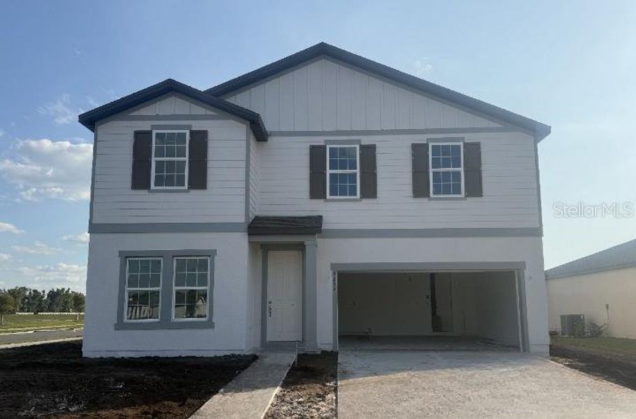 Front exterior of a new home in Tyson Reserve, St. Cloud, FL, highlighting curb appeal (Image 2). Front exterior of a new home in Tyson Reserve, St. Cloud, FL, highlighting curb appeal (Image 2).