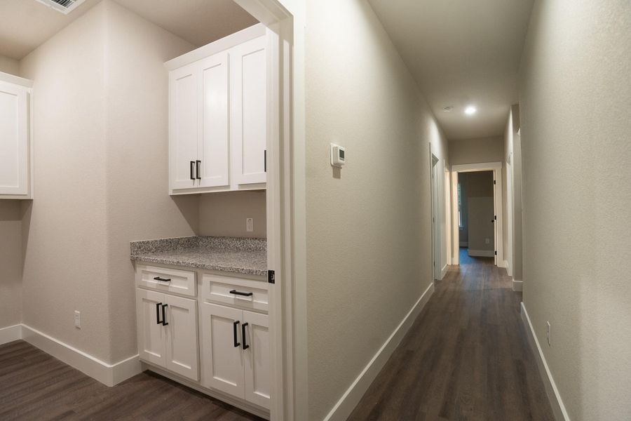 Hall with dark wood-style floors, baseboards, and recessed lighting Hall with dark wood-style floors, baseboards, and recessed lighting