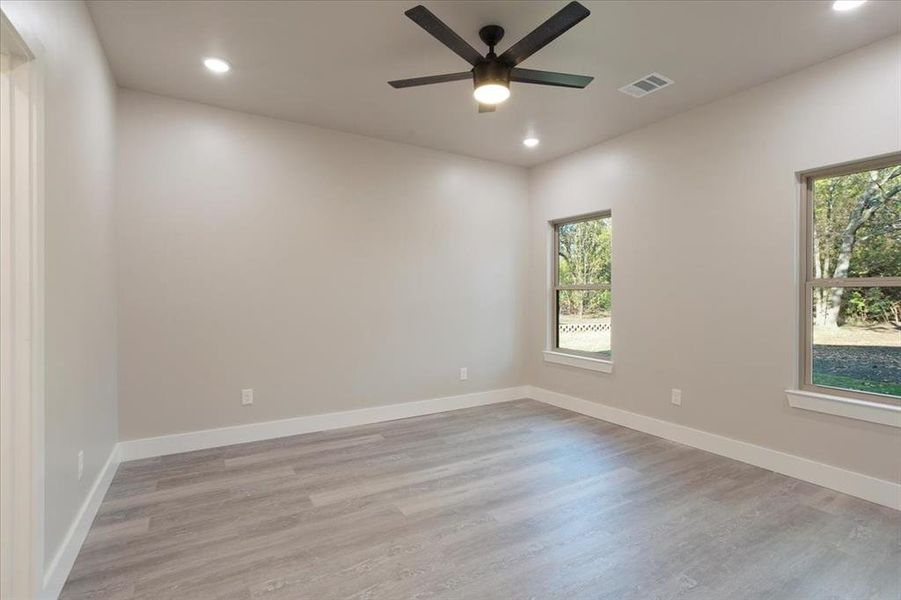 Spare room featuring light wood-type flooring and ceiling fan