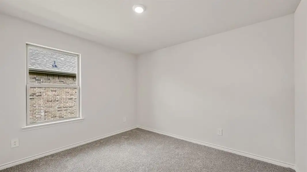 Carpeted room featuring a single window with white trim, a recessed ceiling light, and light-colored walls with matching baseboards Carpeted room featuring a single window with white trim, a recessed ceiling light, and light-colored walls with matching baseboards