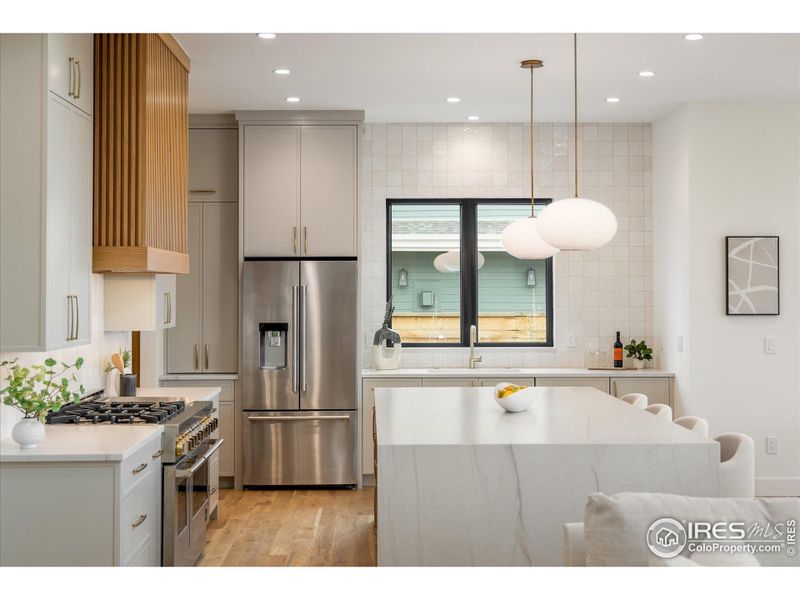 A gourmet kitchen with custom cabinets, expansive island, and ample counter space!