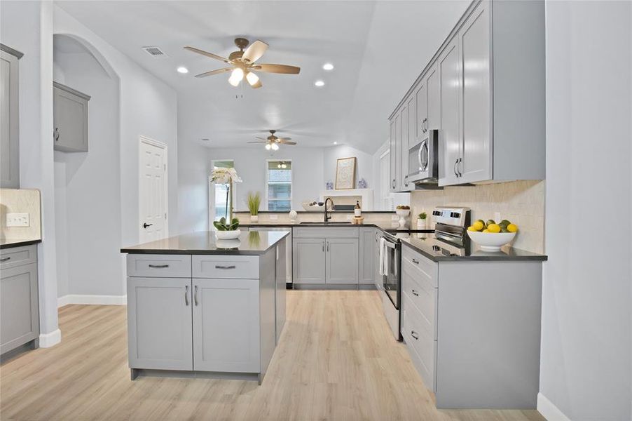 Kitchen with tons of storage space, pantry and ceiling fan.