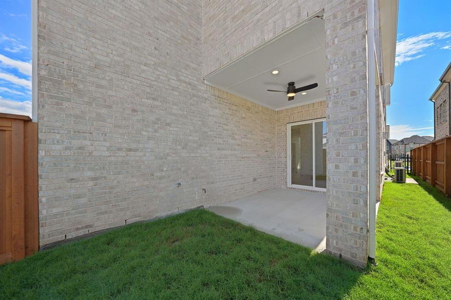 View of yard with ceiling fan and a patio area
