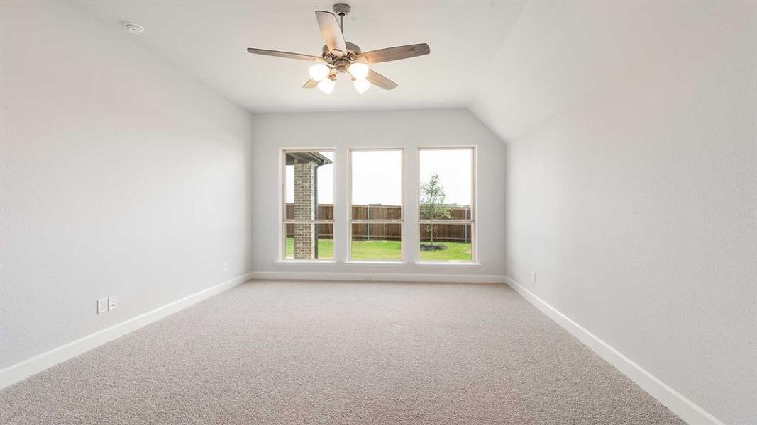 Bonus room featuring light carpet, lofted ceiling, and ceiling fan