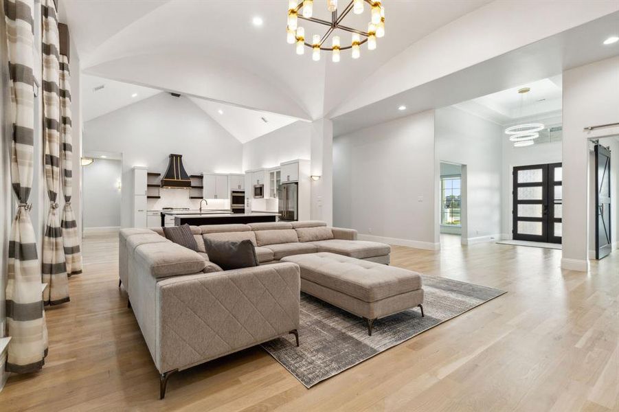 Groin vault family room ceiling and designer chandelier bring architecture detail and interest to ceilings