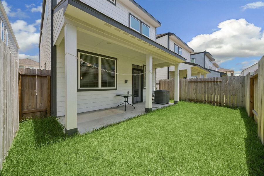 Exterior details and patio area of a home in Dunvale Village - Townhome Collection, Houston (Image 3).