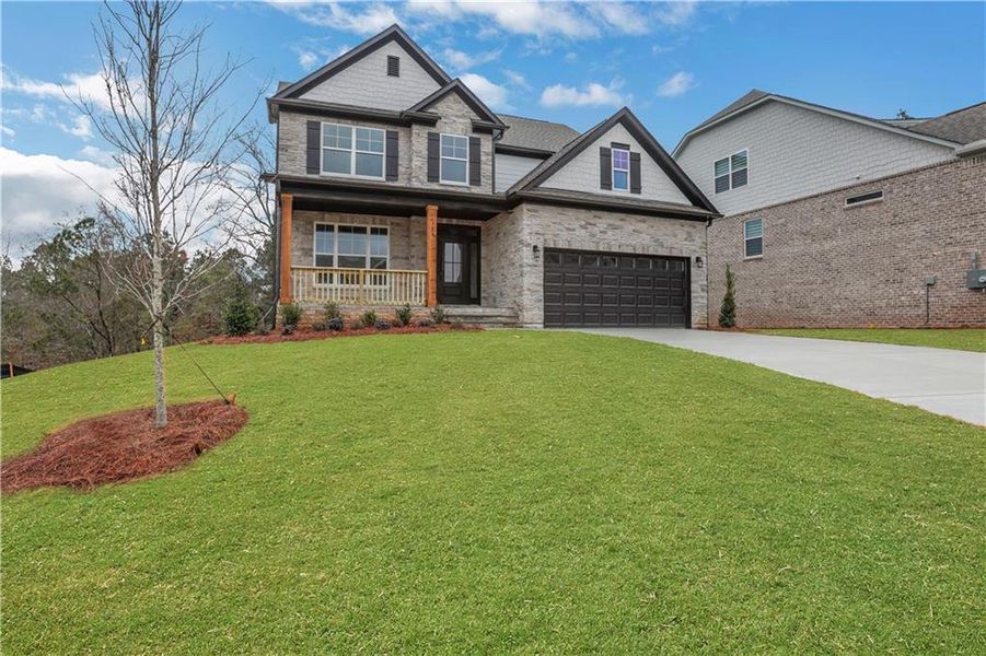 Front exterior of a new home in Cambridge, Flowery Branch, GA, highlighting curb appeal (Image 22). Front exterior of a new home in Cambridge, Flowery Branch, GA, highlighting curb appeal (Image 22).