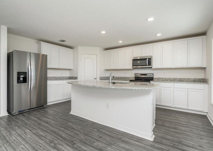 The kitchen is chef-ready with stainless steel appliances