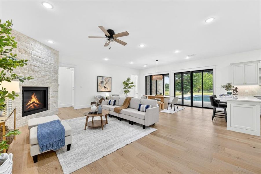 Open and light family room with dining room and open kitchen.  Gorgeous slider doors allow for indoor and outdoor entertaining!